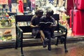 Vintage bronze statue of boy and girl sitting on the bench and reading a book, Times Square, New York.