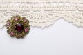 Vintage brooch on lace background Royalty Free Stock Photo