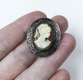 cameo jewelry in the hand of a woman on a white background Royalty Free Stock Photo