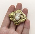 cameo Jewelry brooch in hand on a white background close up Royalty Free Stock Photo
