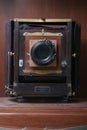 Vintage folding camera on a dusty shelf