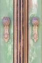Vintage brown and green wooden door with metal door handles Royalty Free Stock Photo