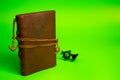 Vintage brown leather note pad. green background. Royalty Free Stock Photo