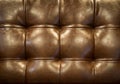 Vintage brown leather upholstery buttoned sofa (background)