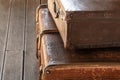 Vintage brown old faded suitcases stack luggage travel design on a dark background Royalty Free Stock Photo