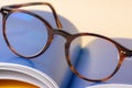 Brown reading glasses lying on opened book close-up Royalty Free Stock Photo