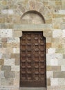 Vintage brown wood old door in the medieval sity of Pisa, Italy