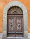 Vintage brown wood old door in the medieval sity of Pisa, Italy