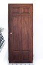 Vintage brown wooden door on white wall Royalty Free Stock Photo