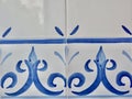 Vintage brush painted tiles of white and blue colour. Spanish decorative tiled covering