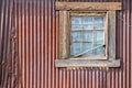 Vintage building, window against corrugated metal siding Royalty Free Stock Photo