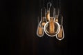 Vintage bulbs on black background - idea, innovation, teamwork and leadership concept. Space for text Royalty Free Stock Photo