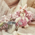 Vintage bunnie with small garden watering can, spring flowers hyacinth. Romantic still life. Gift on Valentin`s, Mothers