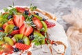 Vintage cake stand with Meringue dessert Pavlova with sugar powder, fresh strawberries, kiwi, blueberries and mint. Homemade Royalty Free Stock Photo