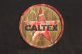 Vintage `Caltex` fuel company logo on the side of a building