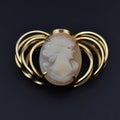 Vintage cameo brooch with the image of the angel on a black background Royalty Free Stock Photo