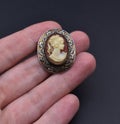 vintage cameo brooch on a woman's hand, old retro jewelry Royalty Free Stock Photo