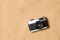 Vintage camera against sandy beach. Studio shot. Copy space.