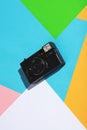 Vintage camera on a colorful geometrical background.