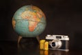 Vintage Camera Film and Globe on Brown with Copy Space Royalty Free Stock Photo