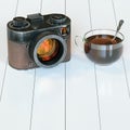 Vintage camera and glass cup of hot tea on white hardwood Royalty Free Stock Photo