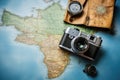 Vintage camera and map of the world, travel and vacation concept, Top view travel concept with retro camera films, map and Royalty Free Stock Photo