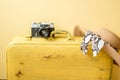 Vintage camera and old bright yellow suitcase. straw hat on a yellow background. Travel and summer vacation concept. Flat lay,top Royalty Free Stock Photo