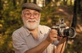 Vintage camera. Old man shoot nature. Professional photographer. Make perfect frame. Landscape nature photo. Old Royalty Free Stock Photo