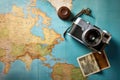 Vintage camera and old map of the world. Travel concept, Top view travel concept with retro camera films, map and passport on blue Royalty Free Stock Photo