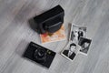 Vintage camera and pictures over wooden background