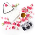 Vintage camera pink roses and note on white background. Flat lay. Top view Royalty Free Stock Photo