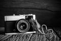 Vintage camera with rose in black and white filter. Royalty Free Stock Photo