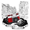 Vintage camera and sneakers on a city street. Vector illustration. Architecture.