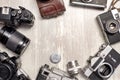 Vintage cameras and lenses on the background of old boards. View from above. Royalty Free Stock Photo