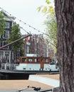 Vintage canal boat is passing by in Amsterdam canal