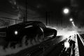 A vintage car in black and white hues speeding along a racetrack with blurred motion, A noir style depiction of illegal street Royalty Free Stock Photo