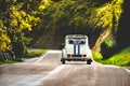 Vintage car country winding road back view friends road trip Royalty Free Stock Photo