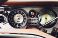 Vintage car dashboard with chrome rims speedometer tachometer. Royalty Free Stock Photo