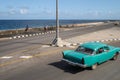 Vintage car driving down the Malecon, Havana, CUBA Royalty Free Stock Photo