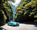 A vintage car driving down a winding road through a dense forest.