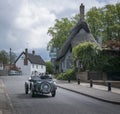 Vintage Car Driving Through Village Royalty Free Stock Photo