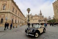 Vintage car in front of the cathedral in Seville Royalty Free Stock Photo