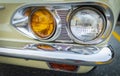 Vintage Car Front Detail. Classic car headlights close-up. Headlights of yellow vintage car. Exhibition Royalty Free Stock Photo