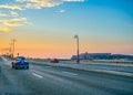 Vintage Car on Highway under Dramatic Sunset