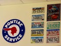 Vintage car license plates from different USA states hanging on the wall Royalty Free Stock Photo