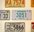 Vintage car license plates from different USA states hanging on the wall Royalty Free Stock Photo