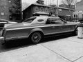 Vintage car near the apartment building. America monochrome image