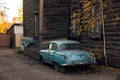 Vintage car near the wooden hause in Tomsk