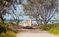 Vintage car parked in beach access with view of sea through rear window Royalty Free Stock Photo