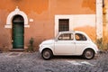 Vintage car parked in a cozy street in Trastevere, Rome, Italy, Europe. Royalty Free Stock Photo